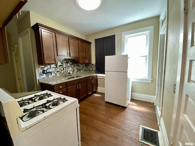 1502 W Columbia Ter, Peoria, IL 61606 - kitchen featuring freestanding refrigerator, stove, a sink, tasteful backsplash, and dark wood-style flooring