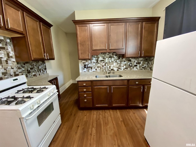 1502 W Columbia Ter, Peoria, IL 61606 - kitchen with white appliances, a sink, dark wood-type flooring, light countertops, and backsplash