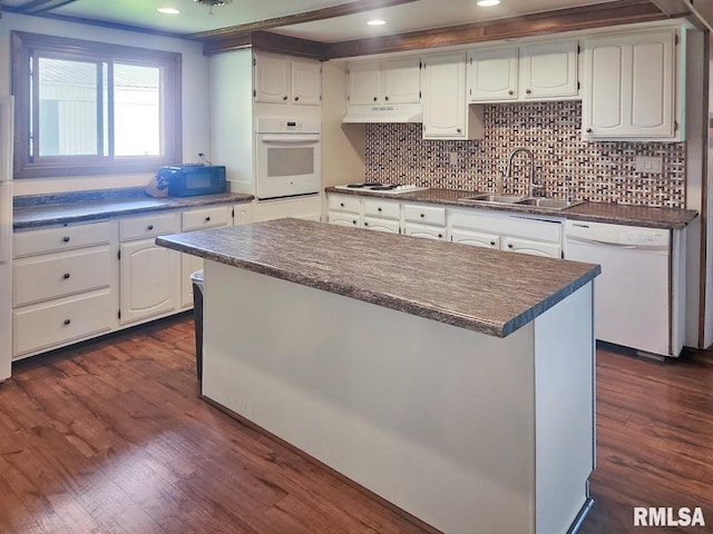 18223 N Slane Rd, Princeville, IL 61559 - kitchen with white appliances, dark countertops, dark wood-style floors, backsplash, and under cabinet range hood