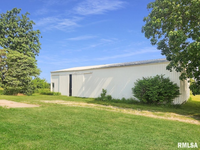 18223 N Slane Rd, Princeville, IL 61559 - view of home's exterior with an outbuilding, a lawn, an outdoor structure, and a detached garage