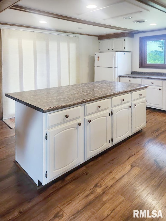 18223 N Slane Rd, Princeville, IL 61559 - kitchen featuring freestanding refrigerator, dark wood-type flooring, white cabinets, a center island, and recessed lighting