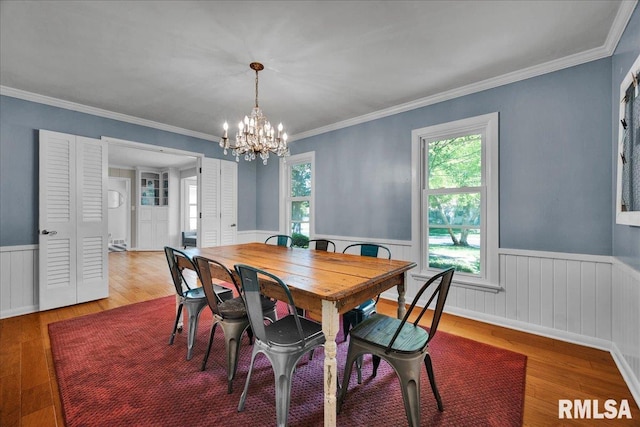 486 E High Point Dr, Peoria, IL 61614 - dining space with a wainscoted wall, hardwood / wood-style flooring, plenty of natural light, a chandelier, and ornamental molding