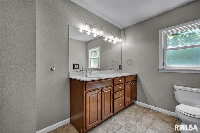 486 E High Point Dr, Peoria, IL 61614 - bathroom with toilet, double vanity, tile patterned flooring, and baseboards