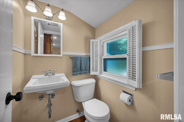 486 E High Point Dr, Peoria, IL 61614 - half bathroom featuring toilet, vaulted ceiling, and a sink