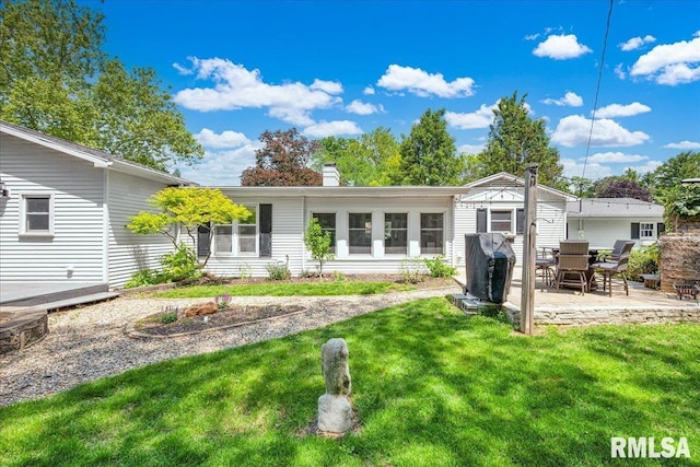 486 E High Point Dr, Peoria, IL 61614 - rear view of house featuring a lawn, a patio area, and a chimney