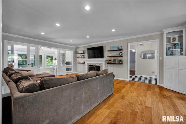 486 E High Point Dr, Peoria, IL 61614 - living room featuring crown molding, light wood-type flooring, recessed lighting, a tiled fireplace, and baseboards