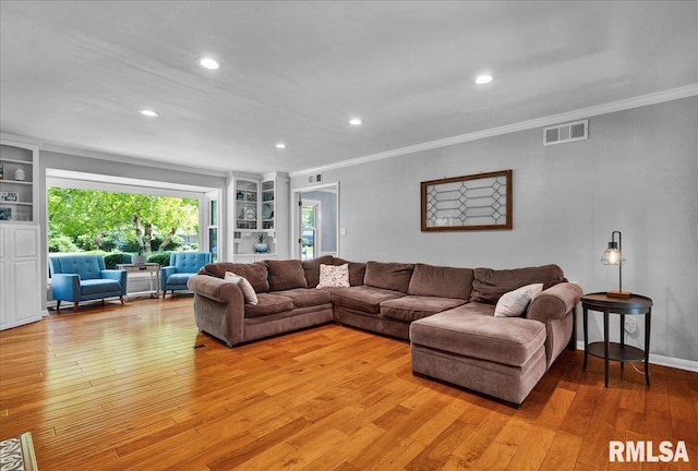 486 E High Point Dr, Peoria, IL 61614 - living area featuring crown molding, light wood-style flooring, recessed lighting, and built in features