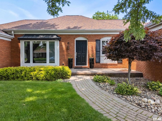 22 Cypress Pt, Pekin, IL 61554 - view of front of house featuring brick siding, a front yard, and a shingled roof