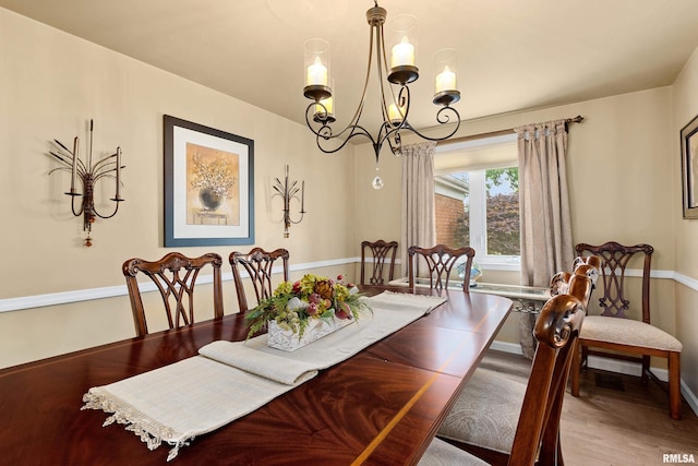 22 Cypress Pt, Pekin, IL 61554 - dining area featuring a chandelier, wood finished floors, and baseboards
