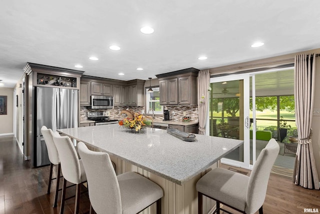 22 Cypress Pt, Pekin, IL 61554 - kitchen featuring appliances with stainless steel finishes, dark wood-style floors, tasteful backsplash, and recessed lighting