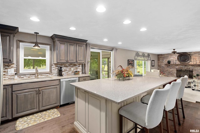 22 Cypress Pt, Pekin, IL 61554 - kitchen featuring a sink, dishwasher, wood finished floors, decorative backsplash, and recessed lighting