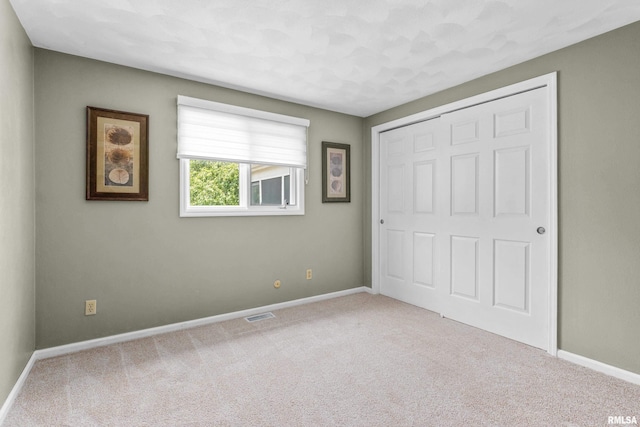 22 Cypress Pt, Pekin, IL 61554 - unfurnished bedroom with carpet flooring, baseboards, and a closet
