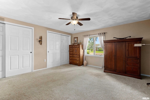 22 Cypress Pt, Pekin, IL 61554 - bedroom with baseboards, two closets, carpet flooring, and a ceiling fan
