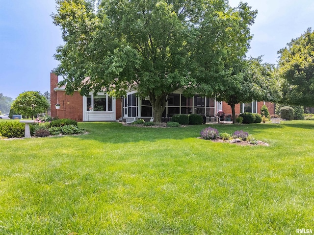 22 Cypress Pt, Pekin, IL 61554 - rear view of house featuring brick siding, a lawn, and a chimney