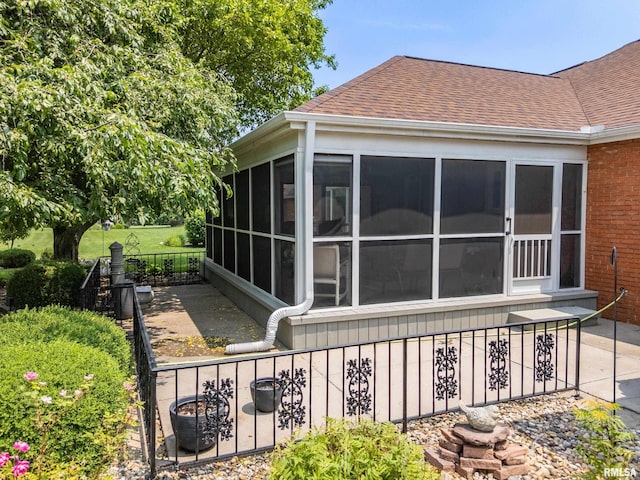 22 Cypress Pt, Pekin, IL 61554 - view of side of property featuring a sunroom, roof with shingles, and brick siding