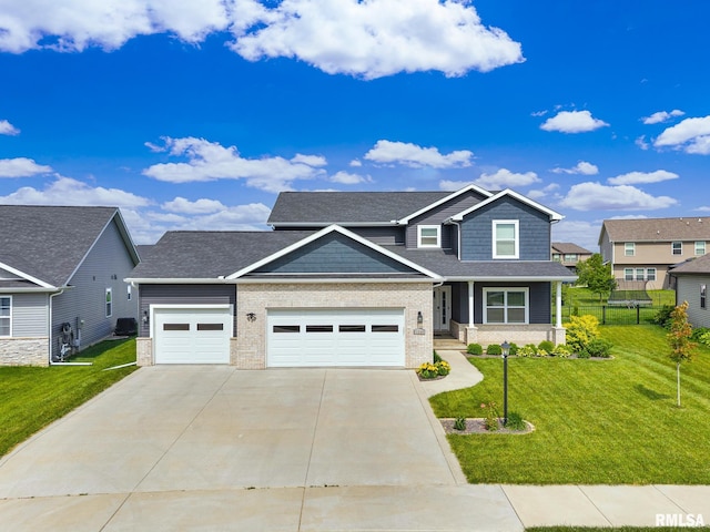 11306 N Joseph St, Dunlap, IL 61525 - view of front of property with driveway, brick siding, a garage, and a front lawn