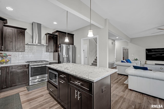 11306 N Joseph St, Dunlap, IL 61525 - kitchen featuring appliances with stainless steel finishes, wall chimney range hood, open floor plan, light wood finished floors, and recessed lighting