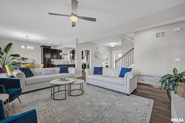 11306 N Joseph St, Dunlap, IL 61525 - living room featuring dark wood-style floors, ceiling fan, a chandelier, and stairs