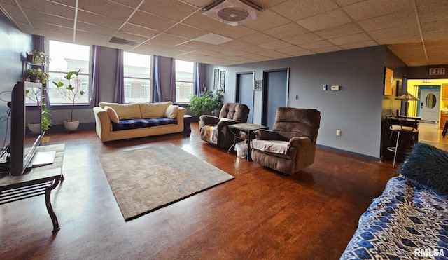 113 N Kickapoo St, Lincoln, IL 62656 - living area with a drop ceiling, baseboards, and wood finished floors