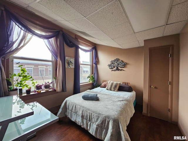 113 N Kickapoo St, Lincoln, IL 62656 - bedroom featuring a drop ceiling and wood finished floors