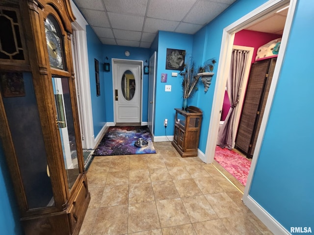 113 N Kickapoo St, Lincoln, IL 62656 - foyer featuring a paneled ceiling, baseboards, and light tile patterned flooring