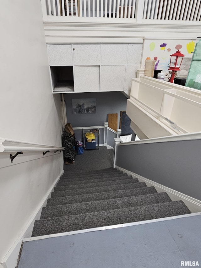 113 N Kickapoo St, Lincoln, IL 62656 - stairs featuring baseboards and carpet floors