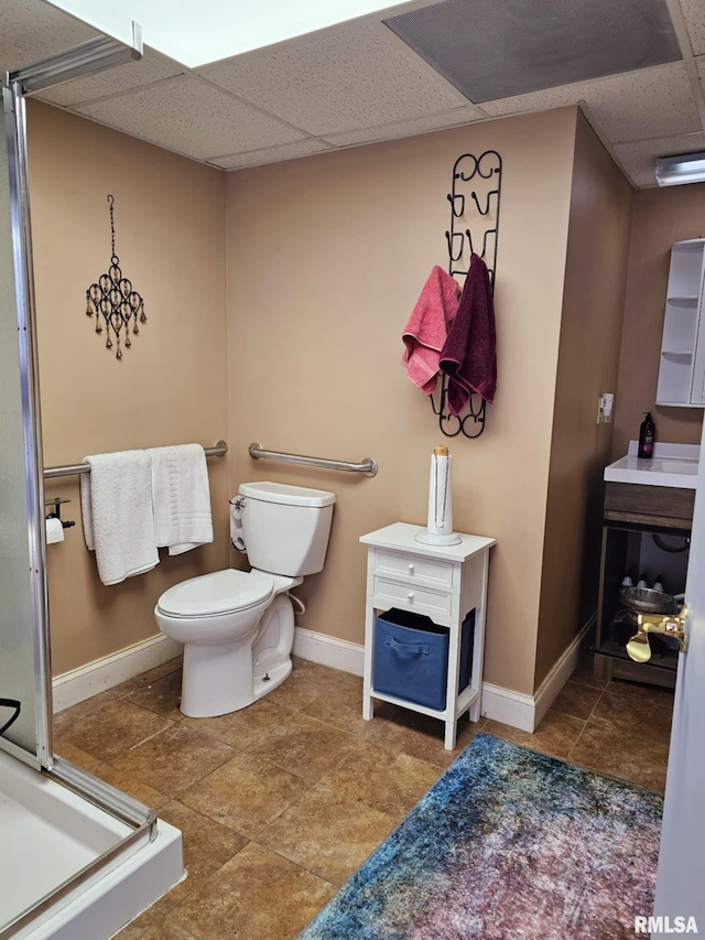 113 N Kickapoo St, Lincoln, IL 62656 - full bathroom with a drop ceiling, toilet, a shower stall, and baseboards
