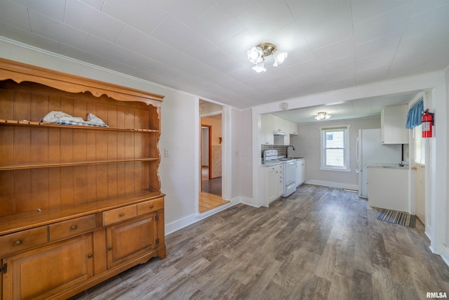 116 S 8th Ave, Canton, IL 61520 - unfurnished dining area with dark wood-style flooring, a sink, and baseboards