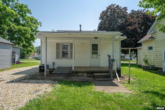 116 S 8th Ave, Canton, IL 61520 - rear view of house with a yard, covered porch, and central AC