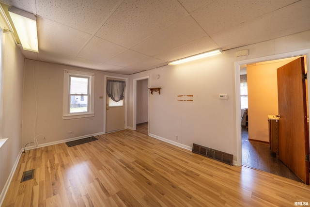 116 S 8th Ave, Canton, IL 61520 - unfurnished room featuring a paneled ceiling, wood finished floors, and baseboards