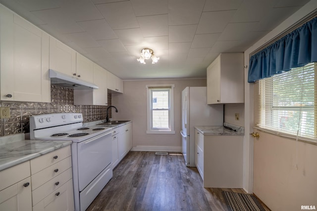 116 S 8th Ave, Canton, IL 61520 - kitchen with white appliances, under cabinet range hood, a sink, white cabinetry, and dark wood-style floors