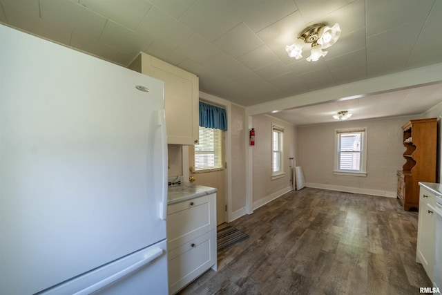 116 S 8th Ave, Canton, IL 61520 - kitchen featuring freestanding refrigerator, white cabinetry, dark wood finished floors, light countertops, and baseboards