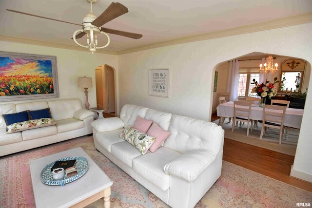 3307 N Biltmore Ave, Peoria, IL 61604 - living area with arched walkways, ornamental molding, wood finished floors, a chandelier, and ceiling fan