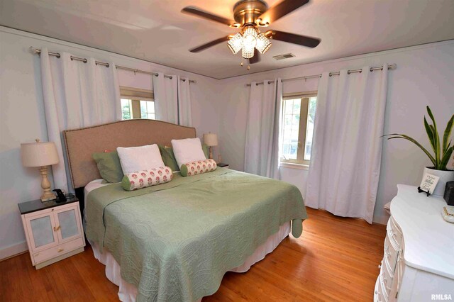 3307 N Biltmore Ave, Peoria, IL 61604 - bedroom with multiple windows, light wood-style floors, and ceiling fan