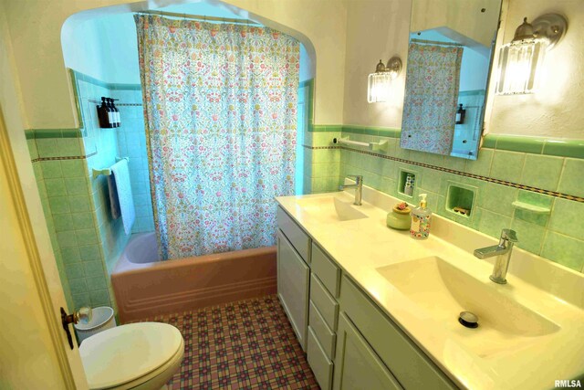 3307 N Biltmore Ave, Peoria, IL 61604 - bathroom featuring tile walls, double vanity, shower / bath combination with curtain, and wainscoting