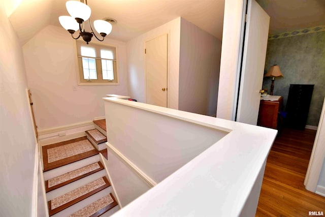3307 N Biltmore Ave, Peoria, IL 61604 - stairs featuring a chandelier, wood finished floors, and vaulted ceiling