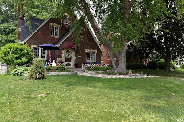 3307 N Biltmore Ave, Peoria, IL 61604 - english style home featuring a front lawn, brick siding, and roof with shingles