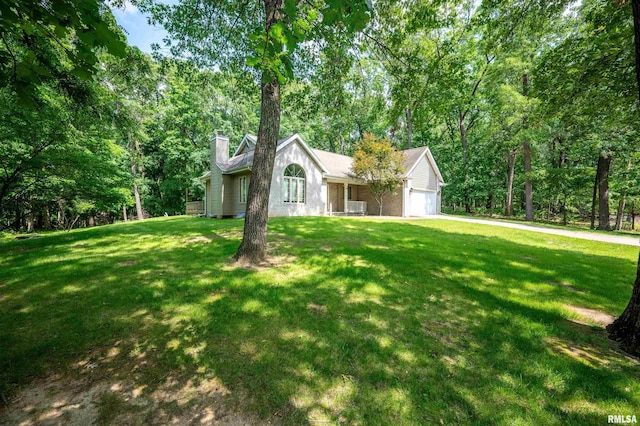 1111 Windy Hill Ct, Varna, IL 61375 - view of front facade featuring a chimney, an attached garage, and a front lawn