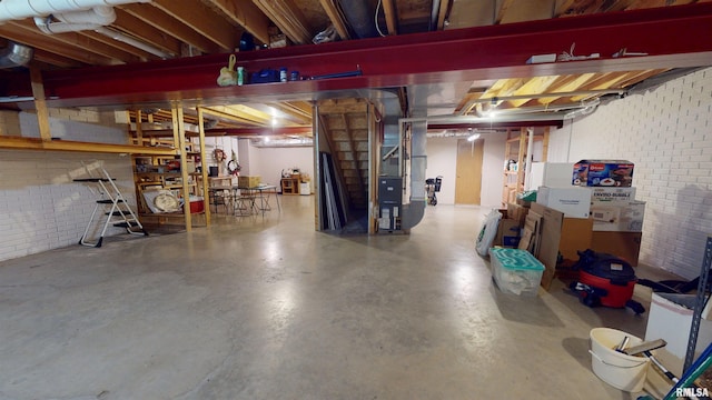 1111 Windy Hill Ct, Varna, IL 61375 - unfinished below grade area with heating unit, brick wall, and stairway