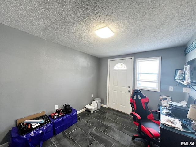 1520 N Finney St, Chillicothe, IL 61523 - foyer entrance featuring a textured ceiling, dark tile patterned floors, and baseboards