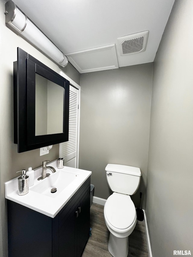 1520 N Finney St, Chillicothe, IL 61523 - half bathroom featuring wood finished floors, vanity, toilet, and baseboards