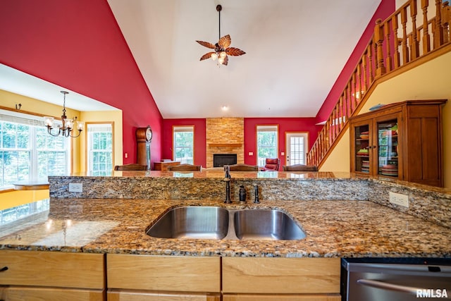 4627 S Queen Aleta Ct, Mapleton, IL 61547 - kitchen with dishwasher, a sink, a ceiling fan, a fireplace, and stone countertops