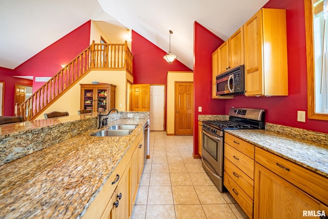 4627 S Queen Aleta Ct, Mapleton, IL 61547 - kitchen with stainless steel appliances, a sink, light stone counters, high vaulted ceiling, and light tile patterned floors