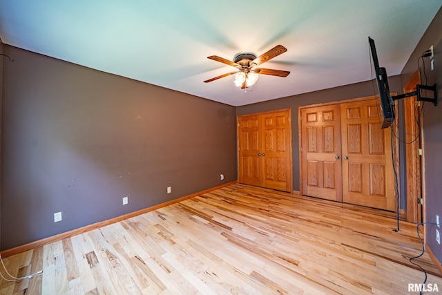 4627 S Queen Aleta Ct, Mapleton, IL 61547 - unfurnished bedroom with wood finished floors, multiple closets, baseboards, and a ceiling fan