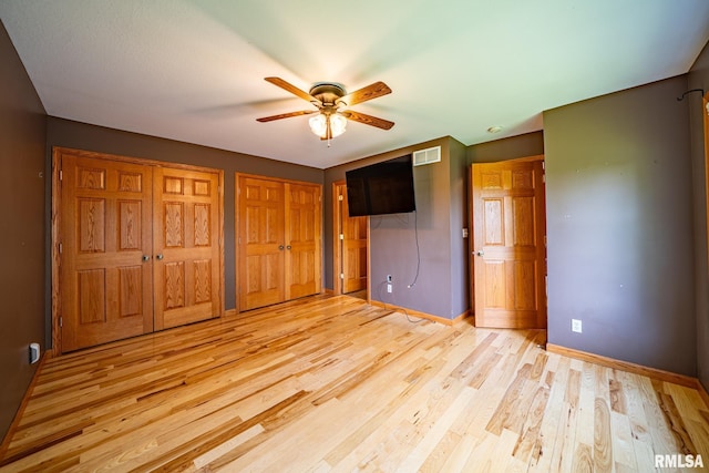 4627 S Queen Aleta Ct, Mapleton, IL 61547 - unfurnished bedroom with two closets, light wood-type flooring, and a ceiling fan