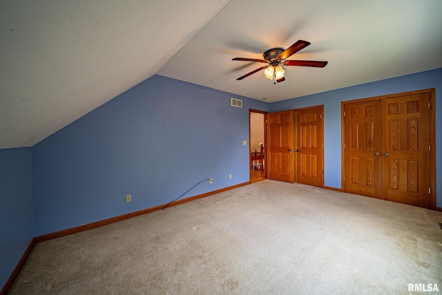4627 S Queen Aleta Ct, Mapleton, IL 61547 - unfurnished bedroom with carpet flooring, baseboards, lofted ceiling, multiple closets, and ceiling fan