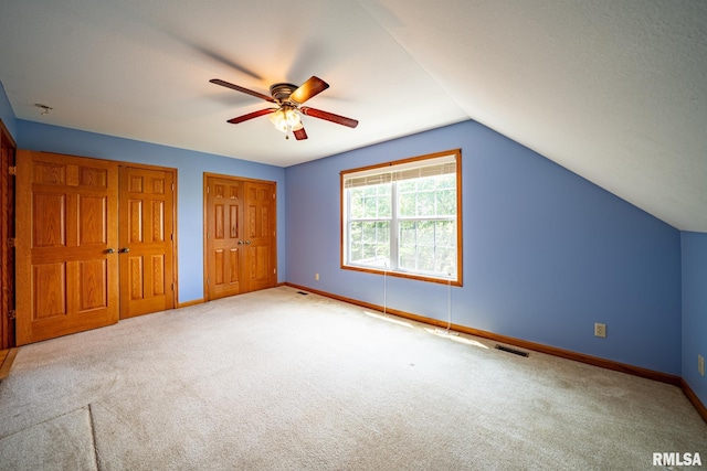 4627 S Queen Aleta Ct, Mapleton, IL 61547 - unfurnished bedroom with carpet, baseboards, vaulted ceiling, two closets, and a ceiling fan