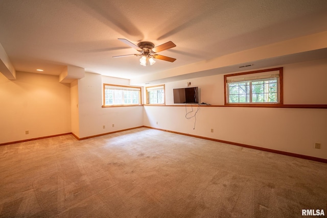 4627 S Queen Aleta Ct, Mapleton, IL 61547 - empty room with light carpet, plenty of natural light, a ceiling fan, and a textured ceiling