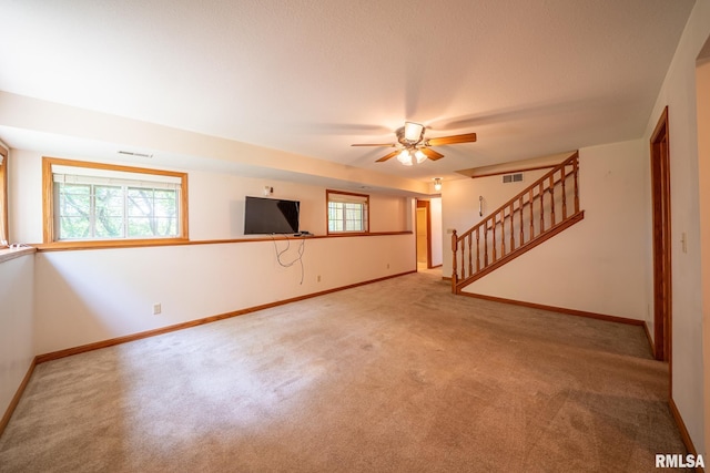 4627 S Queen Aleta Ct, Mapleton, IL 61547 - unfurnished living room with carpet, a ceiling fan, baseboards, and stairway