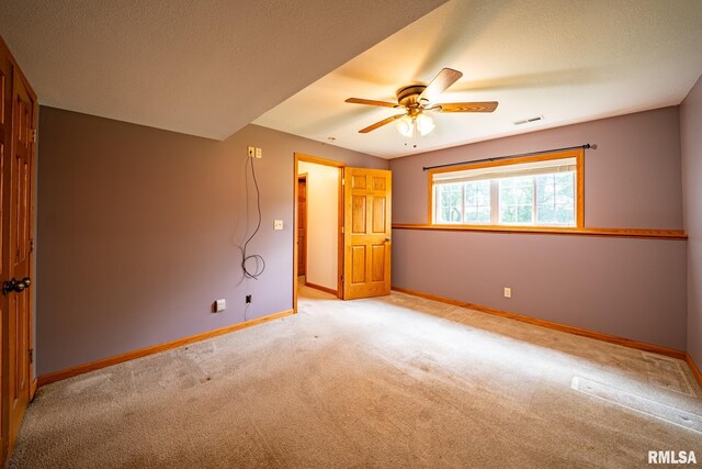 4627 S Queen Aleta Ct, Mapleton, IL 61547 - unfurnished bedroom with light carpet, baseboards, a textured ceiling, and ceiling fan